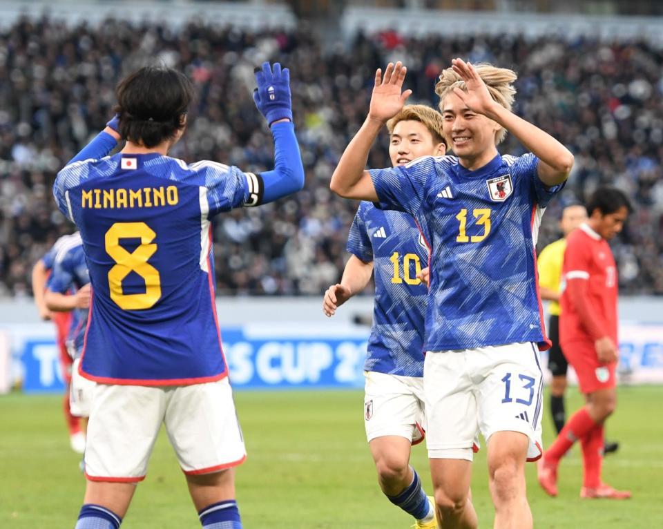 後半、ゴールを決めた南野拓実（左）と笑顔でタッチする中村敬斗＝国立競技場（撮影・棚橋慶太）