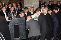 　釜本邦茂さんの柩を霊柩車に入れ込む永島昭浩氏（中央右）