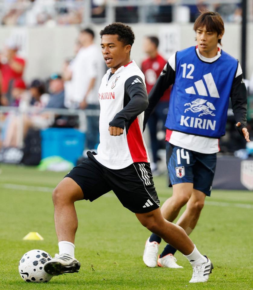 　米国戦を前に、ウオーミングアップする藤田（左）と伊東（共同）