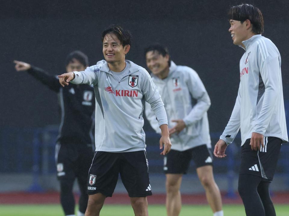 　笑顔で調整する久保建英（撮影・金田祐二）