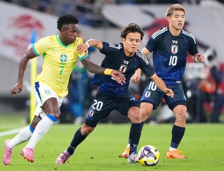 　前半、競り合うブラジルのビニシウス（左）と久保（中央）＝味の素スタジアム