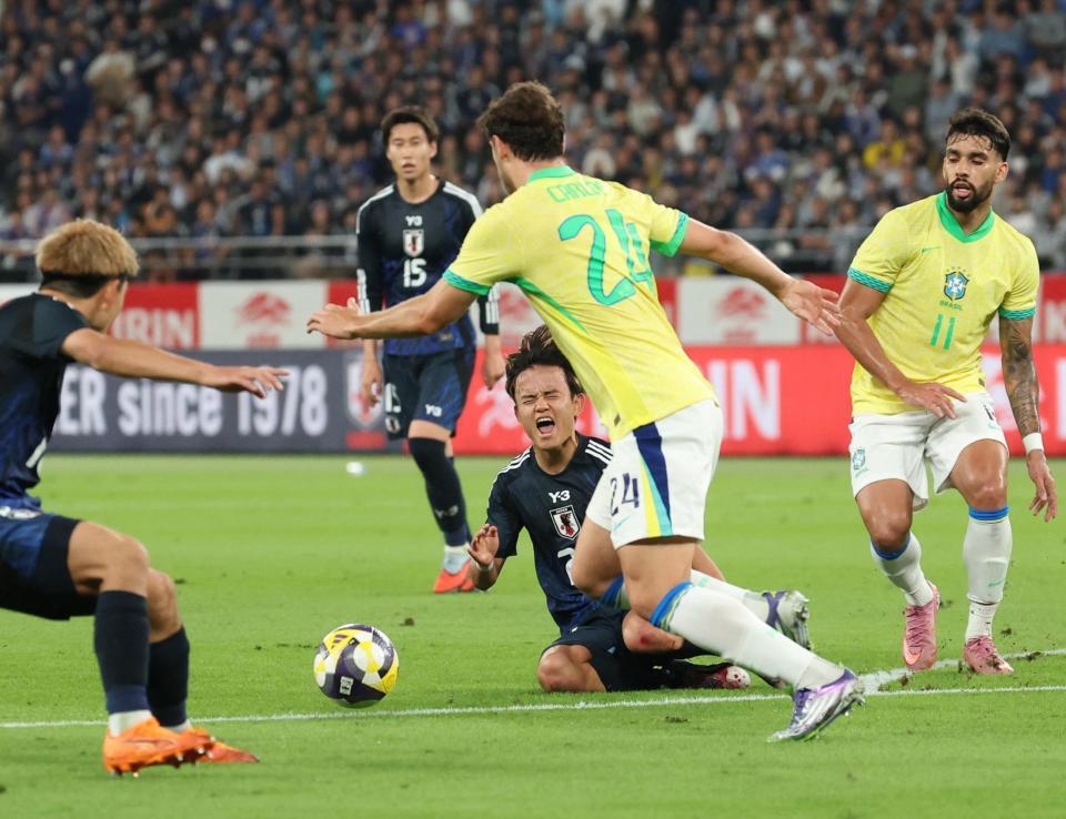 　前半、ブラジル選手と競り合い、声を上げる久保（中央下）