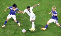 　前半、ガーナ選手を囲む久保（左）と堂安