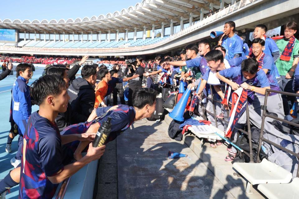 　全国大会初勝利を果たし、スタンドに報告する興国イレブン（撮影・西岡正）