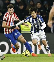 　アトレチコ・マドリード戦の前半、競り合うレアル・ソシエダードの久保（右）＝共同