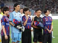 高橋文哉（左端）、櫻井海音（右端）らからＷ杯出場を労われ花束を受け取るＦＣ東京・長友佑都（中央右）＝撮影・吉澤敬太