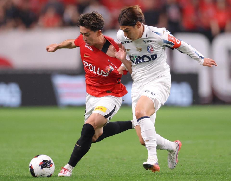 前半、競り合う浦和・宮本優太（左）と岡山・江坂任＝埼玉スタジアム（撮影・吉澤敬太）