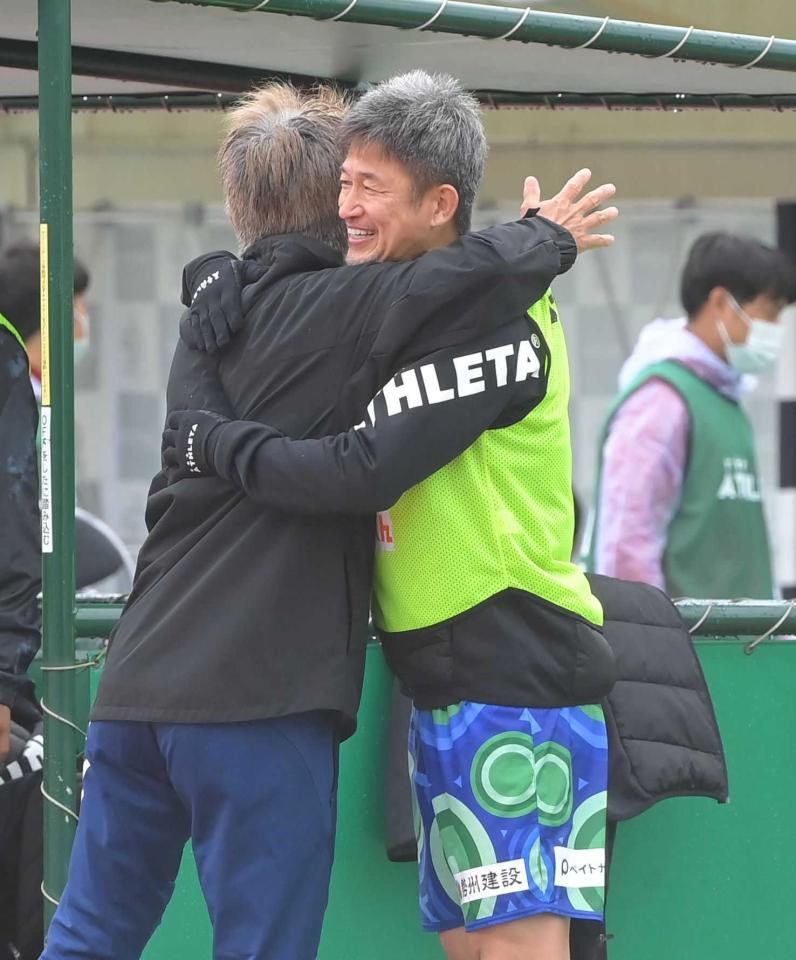 逆転勝利し、鈴鹿・三浦泰年監督（左）と抱き合う三浦知良＝２０２２年５月