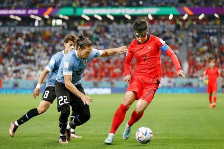 　後半、攻め込む韓国の孫興民（右）＝共同