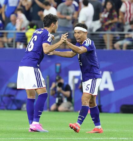 試合を終え、渡辺（左）とタッチを交わす長友（撮影・中田匡峻）