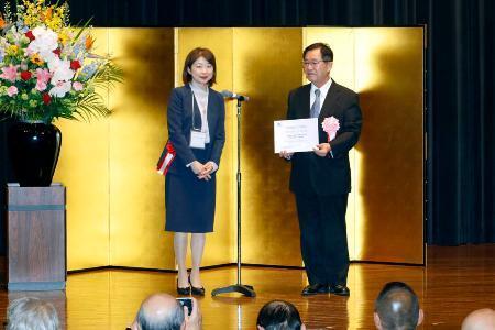 　ユネスコ無形文化遺産の「山・鉾・屋台行事」に追加登録され、認定証を手にする大津祭保存会の古家弘巳会長（右）＝９日午後、新潟県村上市