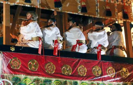 　「平成女鉾」に乗り、祇園ばやしを響かせる平成女鉾清音会のメンバー＝１９日夕、京都市
