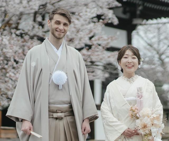 和装姿で笑顔を見せる2人。背景には京都の寺院と満開の桜／投稿主さん提供＝画像をトリミングしています