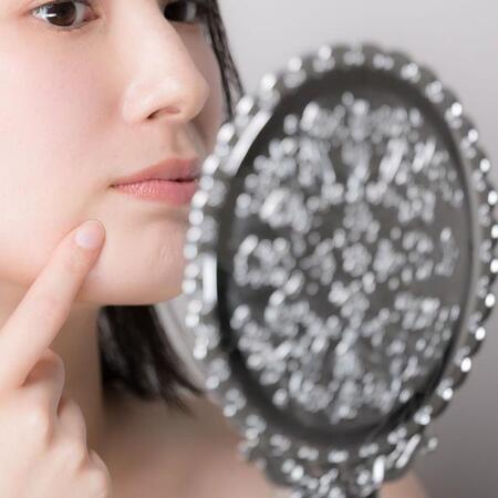 手鏡を見る女性　※画像はイメージです（kapinon/stock.adobe.com）