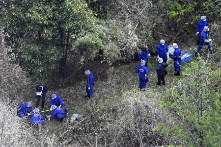 　遺体発見現場付近を調べる京都府警の捜査員ら＝１４日、京都府南丹市