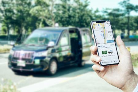　「ＧＯ」が展開するタクシー配車アプリのスマートフォン画面（手前）と対応車両