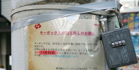 　電柱に設置されたキーボックスと、撤去を命じる警告文＝２７日午後、東京都中央区（書類送検された男性のボックスとは別物です）