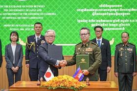 　カンボジアの首都プノンペンで開かれた署名式に出席する植野篤志駐カンボジア大使（手前左）とティア・セイハ副首相兼国防相（手前右）＝１９日（外務省提供）