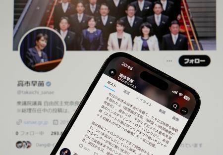 　高市首相が２０日に自身のＸ（旧ツイッター）に投稿した文面（手前）。「就任以来、０時間～３時間睡眠が常態化」などと記されている