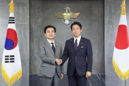 　６月２８日、ソウルの韓国国防省で握手する小泉防衛相（右）と韓国の安圭伯国防相（韓国国防省提供・共同）