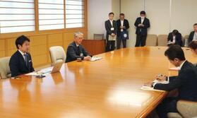 　資源エネルギー庁の久米孝電力・ガス事業部長（右）から報告を受ける宮下宗一郎青森県知事（左）＝３日午後、青森県庁