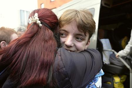 　昨年３月、ロシアが２０１４年に併合したクリミア半島の施設から帰還し、キーウで母親と再会して抱き合う子ども（共同）