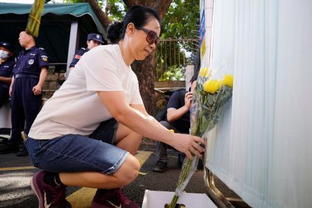 　男子児童が通っていた日本人学校前に花を手向ける市民＝１９日、中国広東省深セン市（共同）