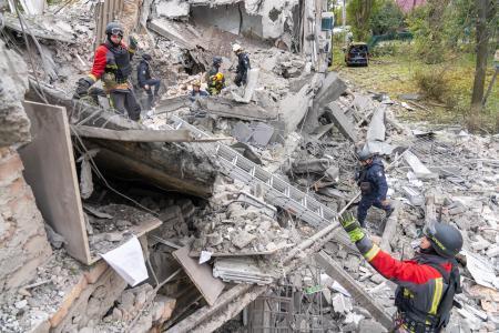 　ロシア軍の攻撃で破壊された住宅で、救助活動をする当局者ら＝２１日、ウクライナ南部ザポロジエ州（同州提供・ゲッティ＝共同）