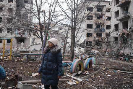 　ウクライナ東部ドネツク州で、破壊されたアパートの残骸から所持品を集める住民＝１４日（ゲッティ＝共同）