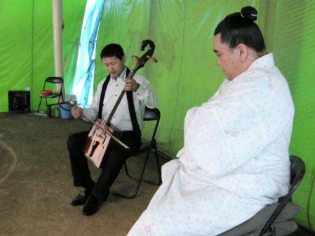 土俵のあるテント内で馬頭琴の演奏に聞き入る日馬富士＝大阪市内の公園
