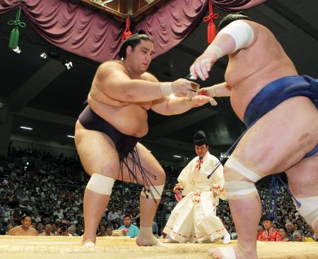 　若の里（右）を押し出しで下す魁聖（撮影・田中久雄）