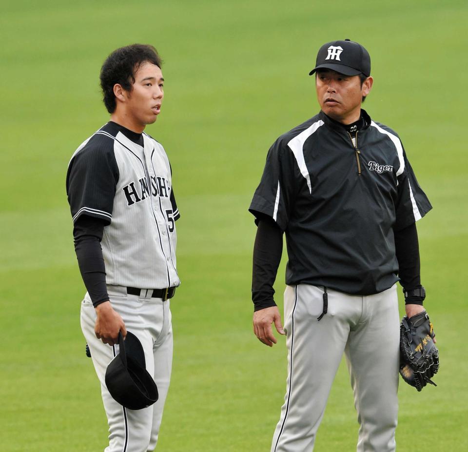 　練習中に香田コーチ（右）と話し込む青柳