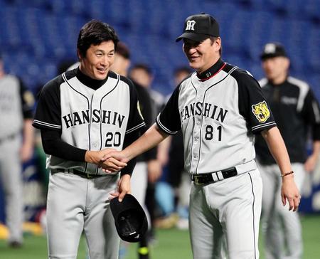 試合開始前、片岡コーチ（右）と握手を交わす阪神・筒井＝ナゴヤドーム（撮影・北村雅宏）