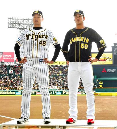 来季着用するユニホームを披露する秋山（左）と中谷（撮影・北村雅宏）　　