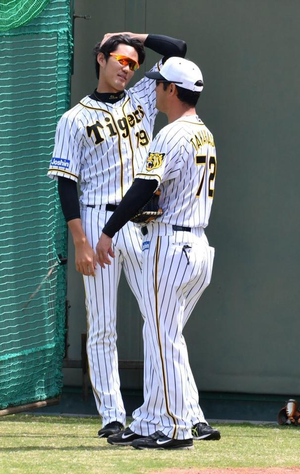 ブルペンでの投球練習を終え高橋建投手コーチ（右）と話す藤浪晋太郎＝鳴尾浜（撮影・持木克友）