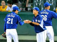 最後を締めた岡田（左）から、プロ初勝利のウイニングボールを嬉しそうに受け取る山本（撮影・吉澤敬太）