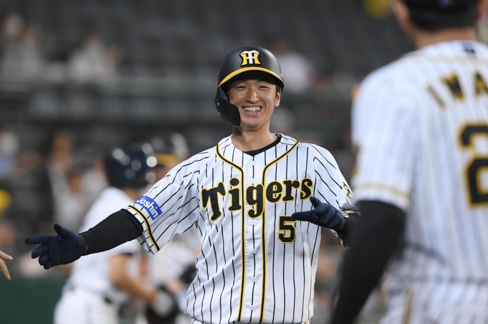 ６回、相手投手の暴投の間に生還した阪神・近本は笑顔でベンチへ戻る＝甲子園（撮影・田中太一）