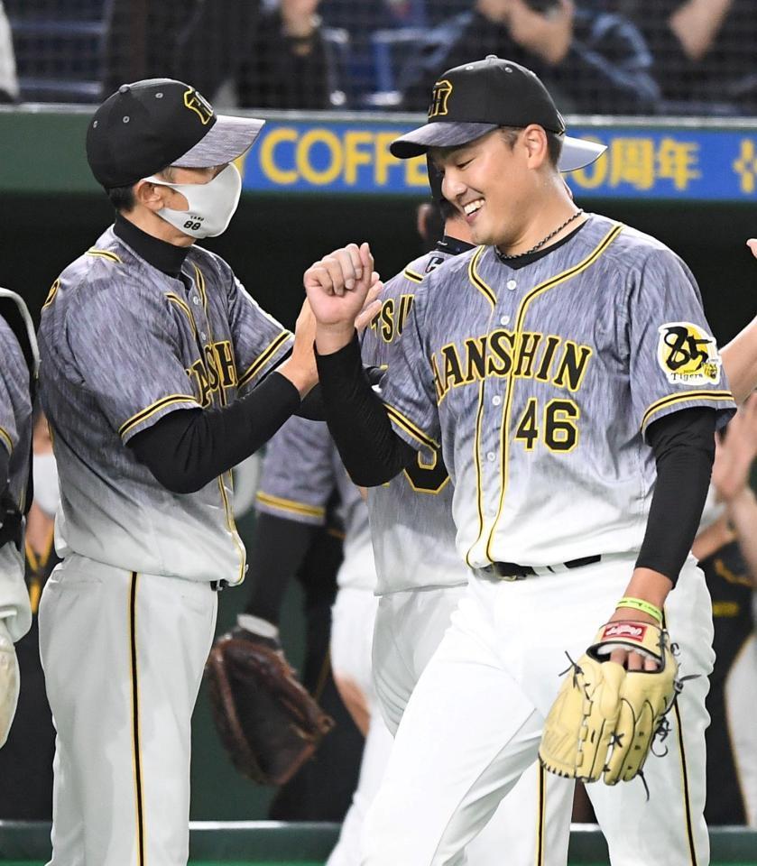 完投勝利を挙げた阪神・秋山（右）を迎える阪神・矢野監督＝東京ドーム（撮影・中田匡峻）