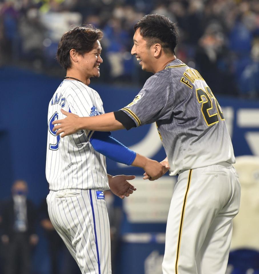 試合終了後、グラウンドに登場し、ＤｅＮＡ・大和（左）と抱き合う阪神・藤川＝横浜スタジアム（撮影・西岡正）