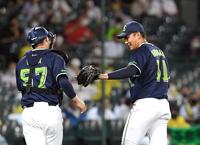 　７回、ヤクルト・奥川は阪神・中野を空振り三振に打ち取り、古賀とグラブタッチしベンチに戻る（撮影・山口登）