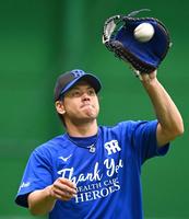 　医療従事者に感謝を示す青いＴシャツ姿で練習に励む梅野＝１８日