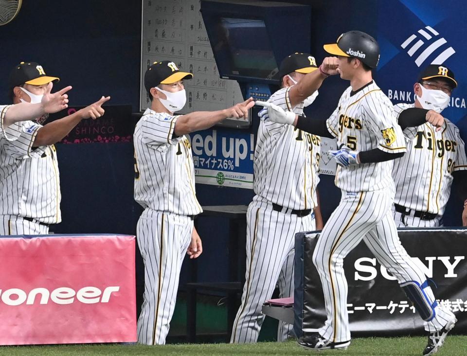 １回、先制ソロを放った阪神・近本光司を迎える阪神・矢野燿大監督ら＝京セラドーム（撮影・飯室逸平）