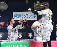 　８回、メダルを手にメル・ロハス・ジュニアを迎える近本光司（撮影・飯室逸平）