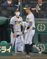 ８回終了後、選手交代を告げにベンチを出る矢野監督。右は佐藤輝（撮影・高部洋祐）