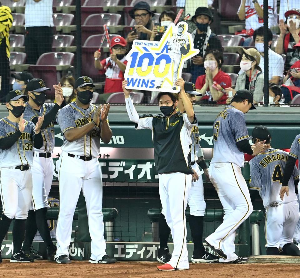 　通算１００勝のボードを掲げる西勇（撮影・飯室逸平）