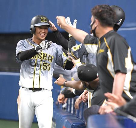 　９回、勝ち越しのホームを踏んだ島田は笑顔でナインとタッチを交わす（撮影・飯室逸平）