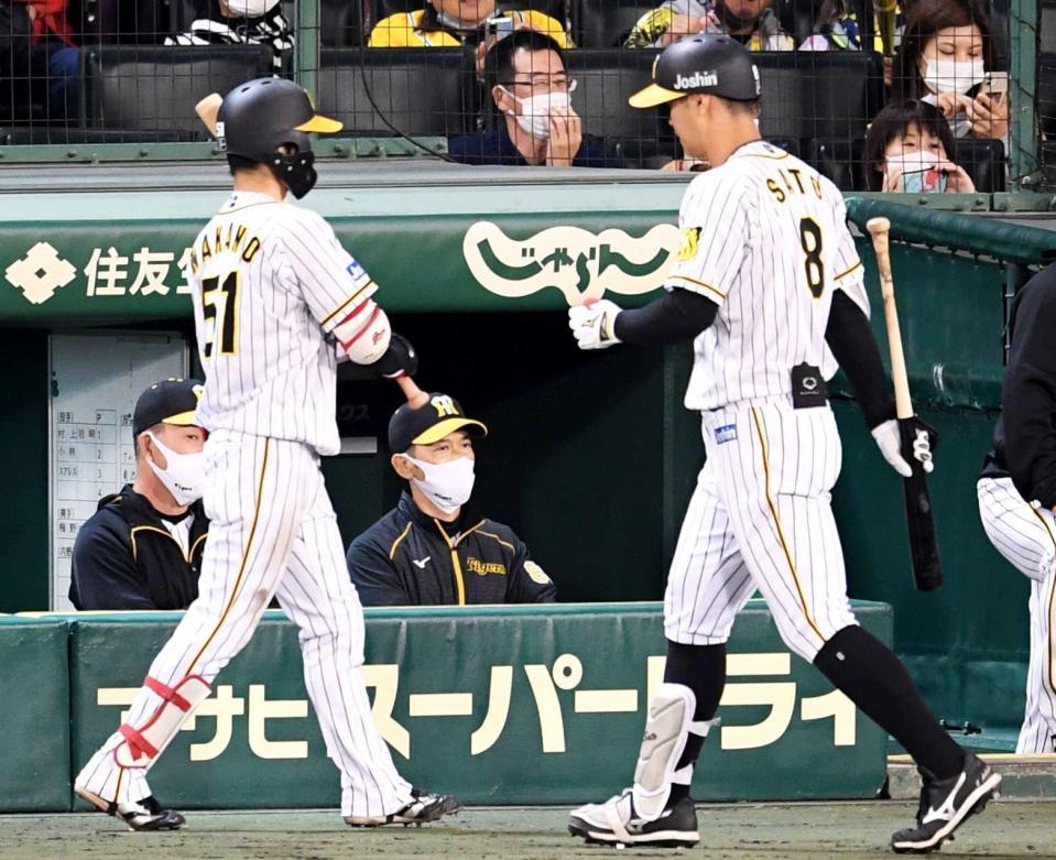 　９回、ベンチから戦況を見つめる矢野監督。右は空振り三振に倒れた佐藤輝（撮影・田中太一）