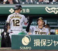 　３回、坂本（左）の先制中犠飛で生還し、笑顔でタッチを交わす佐藤輝（撮影・立川洋一郎）