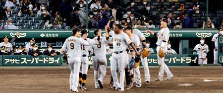 　勝利を喜ぶ巨人ナインを、じっと見つめる矢野監督（右）と阪神ナイン（撮影・田中太一）