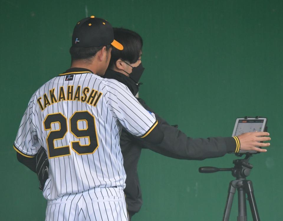 　投球練習を終え映像で確認する高橋（撮影・神子素慎一）